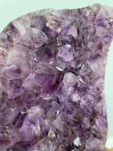 Load image into Gallery viewer, Raw Amethyst cluster with agate edge on stand
